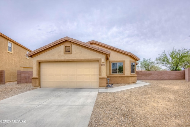 7077 S Cottontail Run Ave, Tucson, AZ 85756 - view of front of house featuring driveway, a garage, and stucco siding