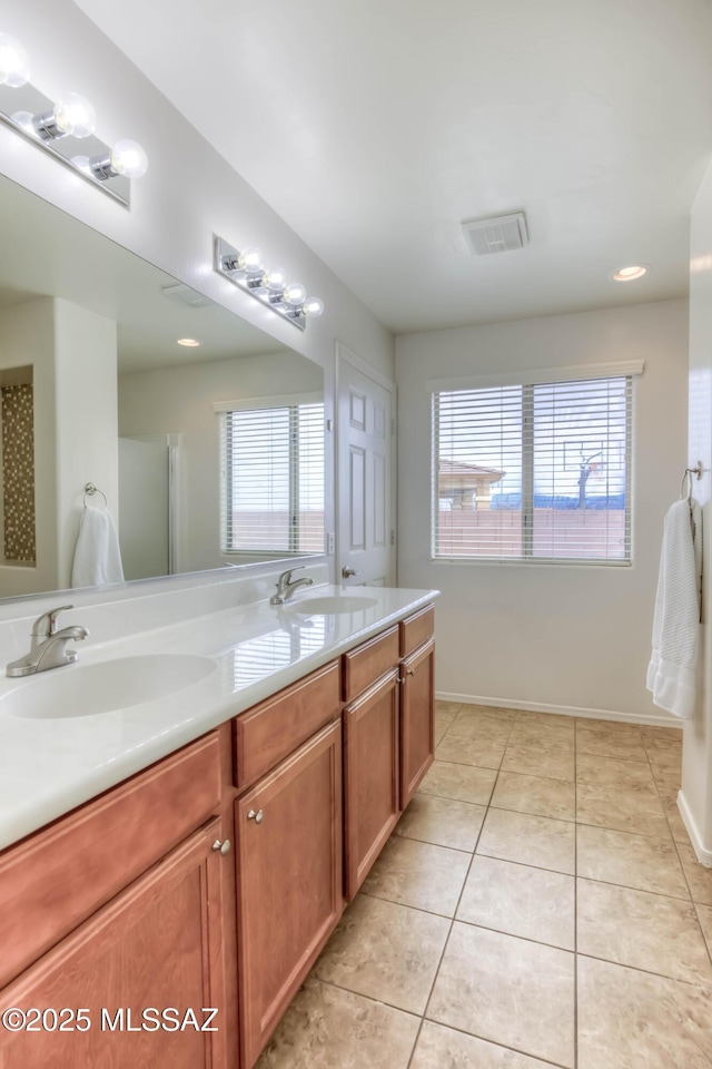 7077 S Cottontail Run Ave, Tucson, AZ 85756 - bathroom featuring double vanity, tile patterned flooring, recessed lighting, and baseboards