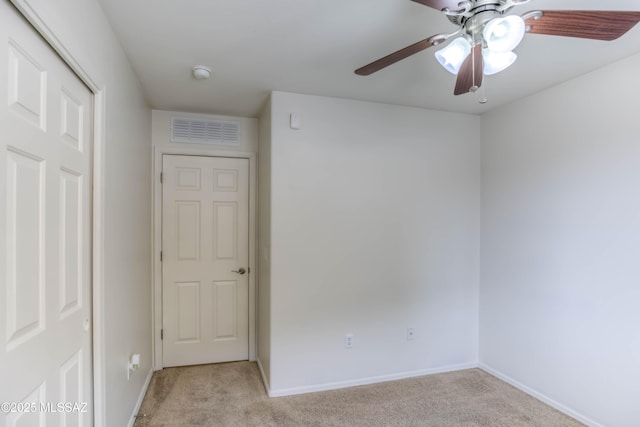 7077 S Cottontail Run Ave, Tucson, AZ 85756 - spare room with light carpet, a ceiling fan, baseboards, and a smoke detector
