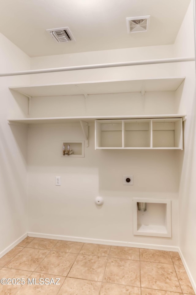 7077 S Cottontail Run Ave, Tucson, AZ 85756 - laundry area with hookup for a gas dryer, washer hookup, hookup for an electric dryer, baseboards, and light tile patterned floors