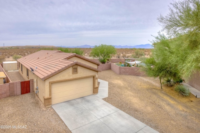 7077 S Cottontail Run Ave, Tucson, AZ 85756 - view of front of house with stucco siding, a mountain view, an attached garage, driveway, and a tile roof