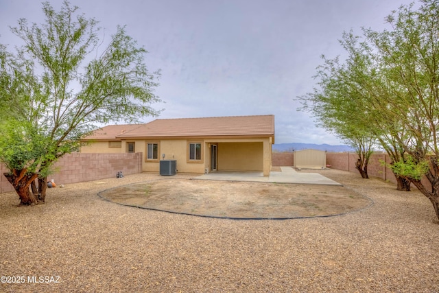 7077 S Cottontail Run Ave, Tucson, AZ 85756 - rear view of property featuring cooling unit, a patio area, a fenced backyard, stucco siding, and a tile roof