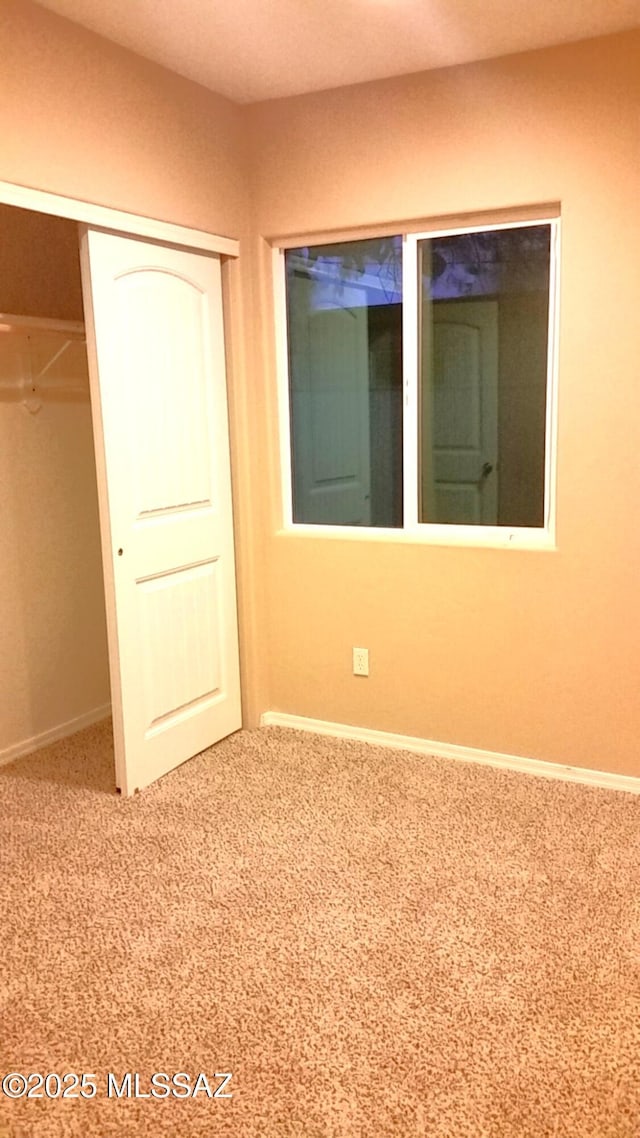 2835 N Euclid Ave, Tucson, AZ 85719 - unfurnished bedroom featuring a closet and carpet flooring