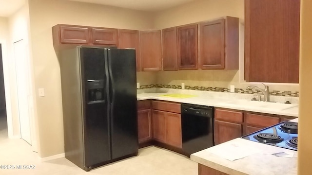 2835 N Euclid Ave, Tucson, AZ 85719 - kitchen featuring black appliances, light countertops, and brown cabinets
