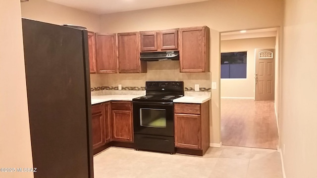 2835 N Euclid Ave, Tucson, AZ 85719 - kitchen with electric range, freestanding refrigerator, under cabinet range hood, light countertops, and recessed lighting