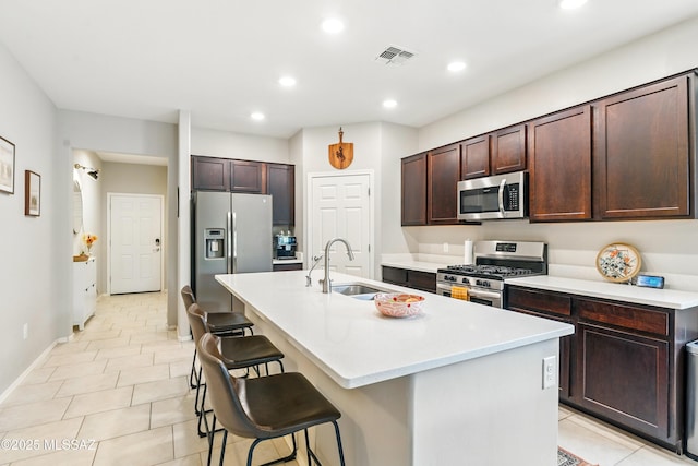 208 E Calle Trona, Green Valley, AZ 85614 - kitchen with appliances with stainless steel finishes, a sink, a kitchen breakfast bar, recessed lighting, and an island with sink