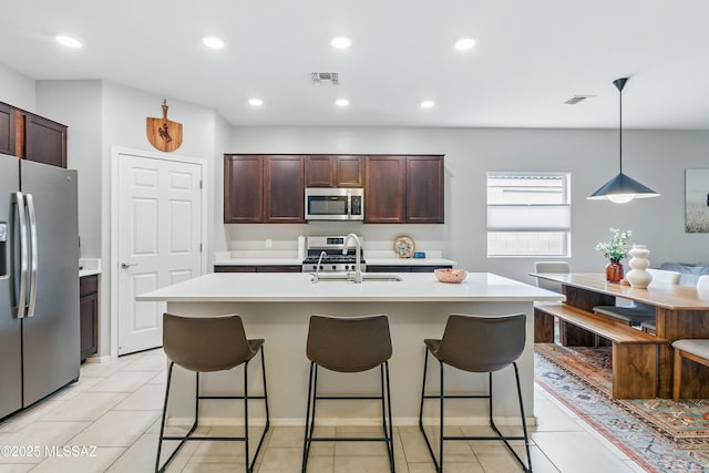208 E Calle Trona, Green Valley, AZ 85614 - kitchen featuring appliances with stainless steel finishes, a sink, light countertops, a kitchen bar, and recessed lighting