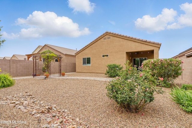 208 E Calle Trona, Green Valley, AZ 85614 - rear view of property featuring stucco siding, a fenced backyard, a patio area, and a tiled roof