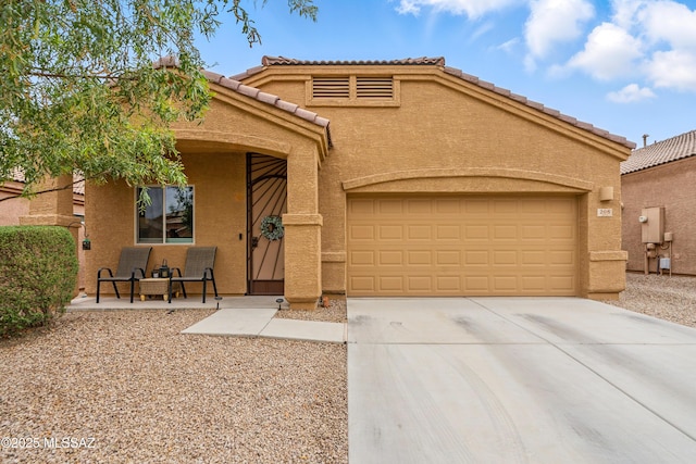 208 E Calle Trona, Green Valley, AZ 85614 - view of front of home with driveway, a garage, stucco siding, and a tile roof