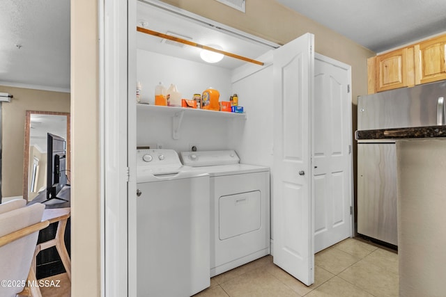 5751 N Kolb Rd Unit 23104, Tucson, AZ 85750 - washroom with washing machine and clothes dryer, light tile patterned flooring, and crown molding