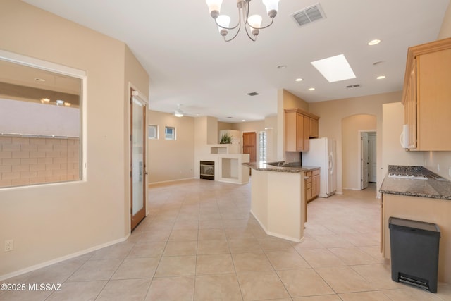 6321 N Via Lomas De Paloma, Tucson, AZ 85718 - kitchen with white appliances, light brown cabinets, open floor plan, dark stone counters, and light tile patterned floors
