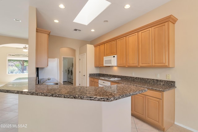 6321 N Via Lomas De Paloma, Tucson, AZ 85718 - kitchen featuring white appliances, washer and dryer, arched walkways, a sink, and recessed lighting