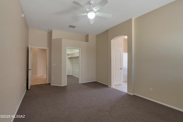 6321 N Via Lomas De Paloma, Tucson, AZ 85718 - spare room with arched walkways, carpet floors, ceiling fan, and baseboards