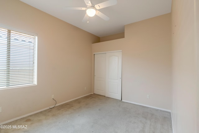 6321 N Via Lomas De Paloma, Tucson, AZ 85718 - unfurnished bedroom featuring light carpet, a closet, baseboards, and a ceiling fan