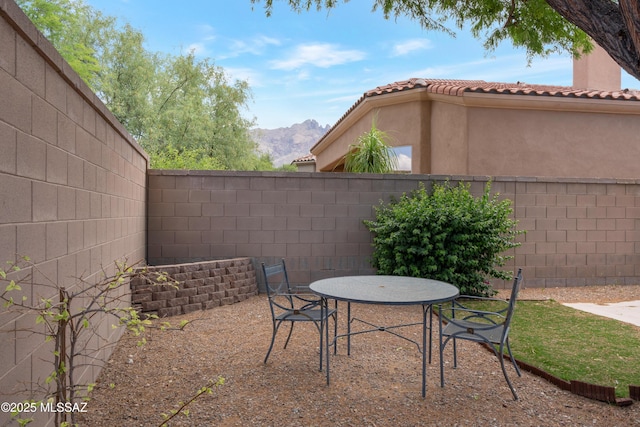 6321 N Via Lomas De Paloma, Tucson, AZ 85718 - fenced backyard with a mountain view, a patio area, and outdoor dining space