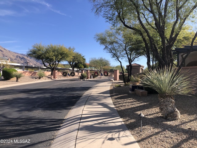 6321 N Via Lomas De Paloma, Tucson, AZ 85718 - view of asphalt road featuring a mountain view and a gated entry