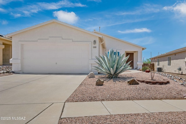 10140 E Pleasant View Way, Tucson, AZ 85748 - view of front of property with driveway, an attached garage, stucco siding, and central AC