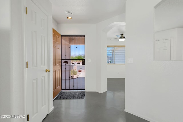 10140 E Pleasant View Way, Tucson, AZ 85748 - entrance foyer with concrete flooring, baseboards, a ceiling fan, and arched walkways