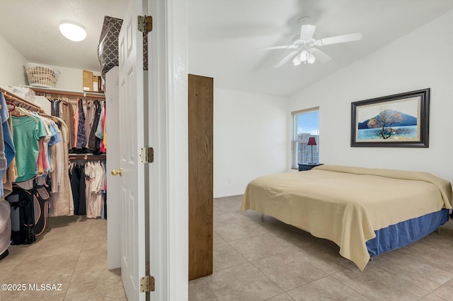 10140 E Pleasant View Way, Tucson, AZ 85748 - bedroom with lofted ceiling, a spacious closet, a closet, light tile patterned flooring, and a ceiling fan