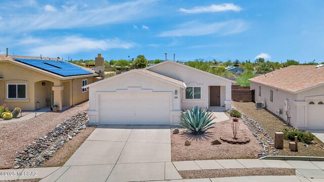10140 E Pleasant View Way, Tucson, AZ 85748 - ranch-style house with driveway, an attached garage, central AC, solar panels, and stucco siding