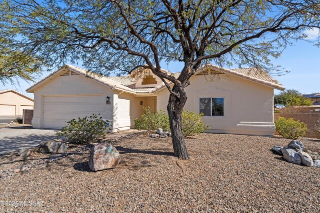 9586 E Paseo, San Bernardo, Tucson, AZ 85747 - view of front of house featuring stucco siding, an attached garage, a tiled roof, and driveway