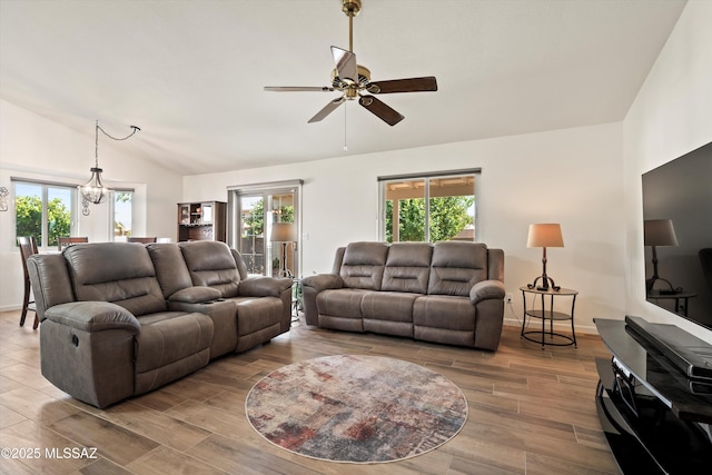9586 E Paseo, San Bernardo, Tucson, AZ 85747 - living area with lofted ceiling, a ceiling fan, healthy amount of natural light, wood finished floors, and baseboards