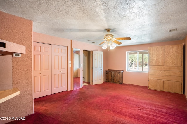 908 E Weymouth St, Tucson, AZ 85719 - unfurnished bedroom with a textured ceiling, a textured wall, carpet flooring, a closet, and a ceiling fan