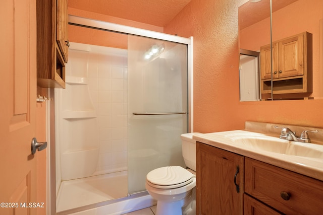 908 E Weymouth St, Tucson, AZ 85719 - bathroom with a textured wall, vanity, a stall shower, and toilet