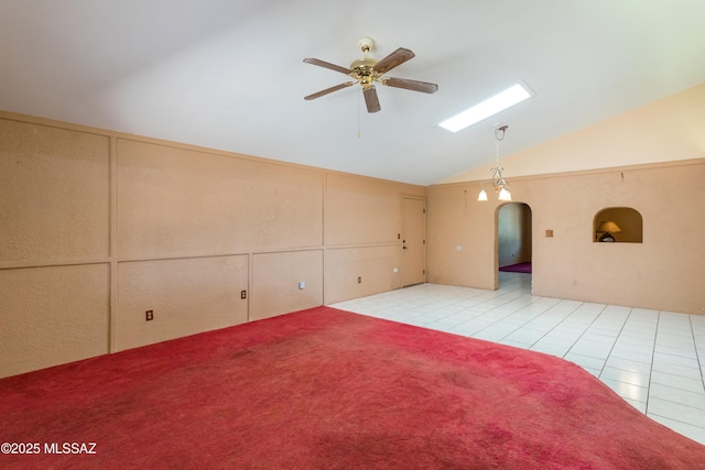 908 E Weymouth St, Tucson, AZ 85719 - unfurnished room with vaulted ceiling, a ceiling fan, arched walkways, and light tile patterned floors