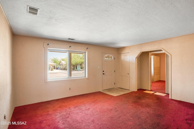 908 E Weymouth St, Tucson, AZ 85719 - carpeted entrance foyer featuring arched walkways and a textured ceiling