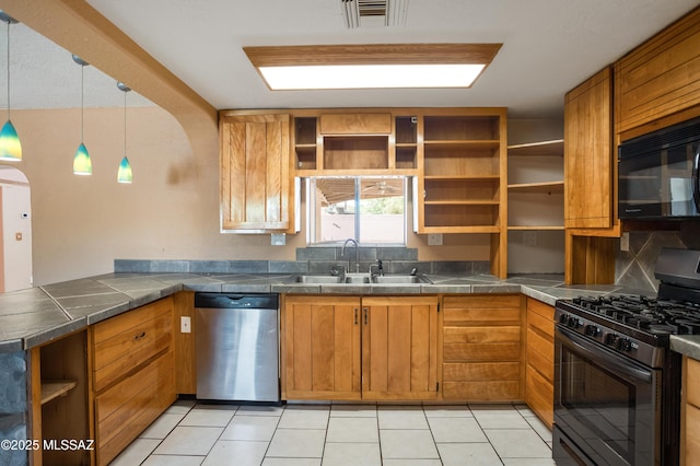 908 E Weymouth St, Tucson, AZ 85719 - kitchen with dishwasher, gas range oven, open shelves, a sink, and black microwave