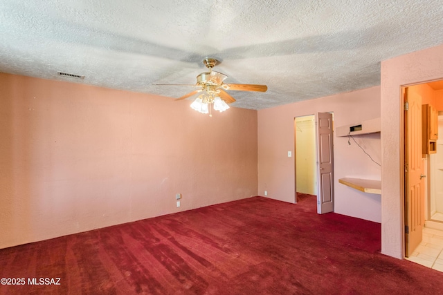908 E Weymouth St, Tucson, AZ 85719 - unfurnished bedroom with a textured ceiling, carpet flooring, a ceiling fan, and ensuite bath