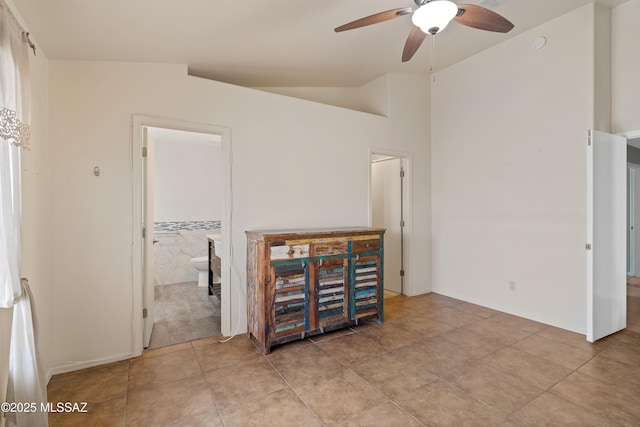 9510 E Danforth Pl, Tucson, AZ 85747 - unfurnished room featuring a ceiling fan, lofted ceiling, light tile patterned floors, and baseboards