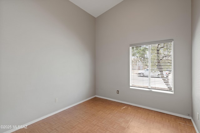 9510 E Danforth Pl, Tucson, AZ 85747 - empty room with baseboards and lofted ceiling