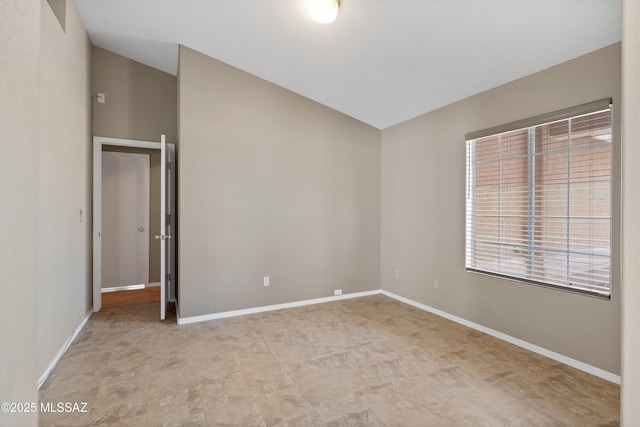 9510 E Danforth Pl, Tucson, AZ 85747 - unfurnished room featuring vaulted ceiling and baseboards