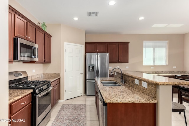 102 E Forrest Feezor St, Vail, AZ 85641 - kitchen featuring stainless steel appliances, a sink, a center island with sink, light tile patterned floors, and light stone counters