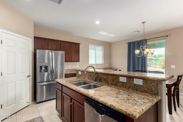 102 E Forrest Feezor St, Vail, AZ 85641 - kitchen featuring stainless steel appliances, a sink, a chandelier, a kitchen island with sink, and decorative light fixtures
