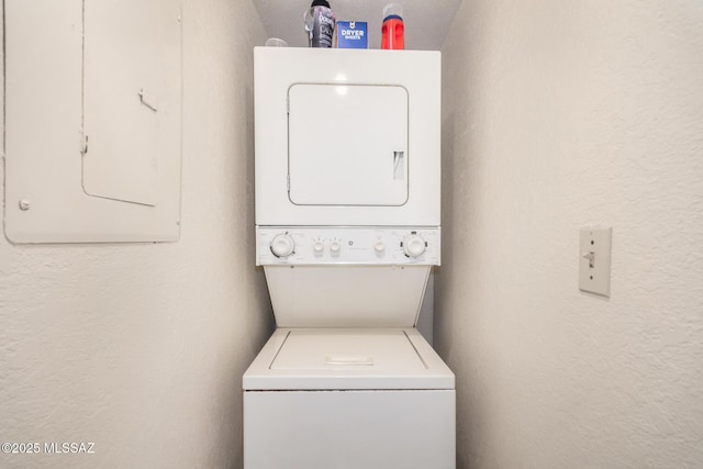 7916 E Colette Cir Unit 51, Tucson, AZ 85710 - washroom featuring estacked washer and dryer, electric panel, and a textured wall