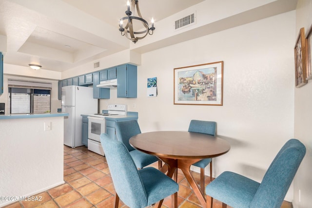 7916 E Colette Cir Unit 51, Tucson, AZ 85710 - dining space featuring a chandelier and a tray ceiling