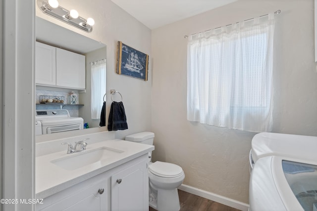 745 N Las Flores Dr, Oracle, AZ 85623 - bathroom with independent washer and dryer, wood finished floors, plenty of natural light, and a textured wall