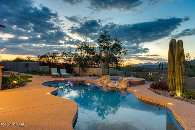 8505 S Circle C Ranch Rd, Vail, AZ 85641 - pool at dusk featuring an in-ground hot tub and a patio area
