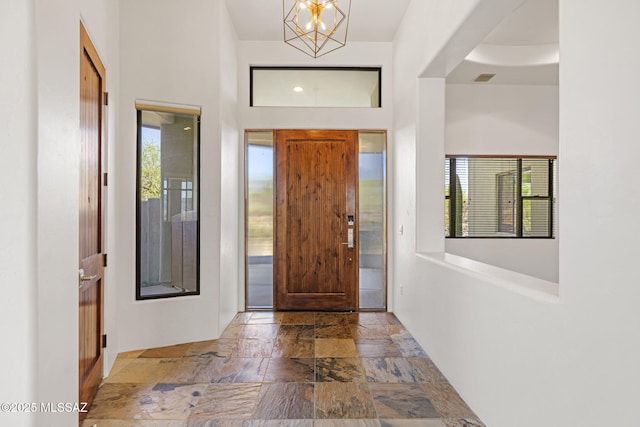 8505 S Circle C Ranch Rd, Vail, AZ 85641 - foyer featuring stone tile floors, healthy amount of natural light, and a chandelier