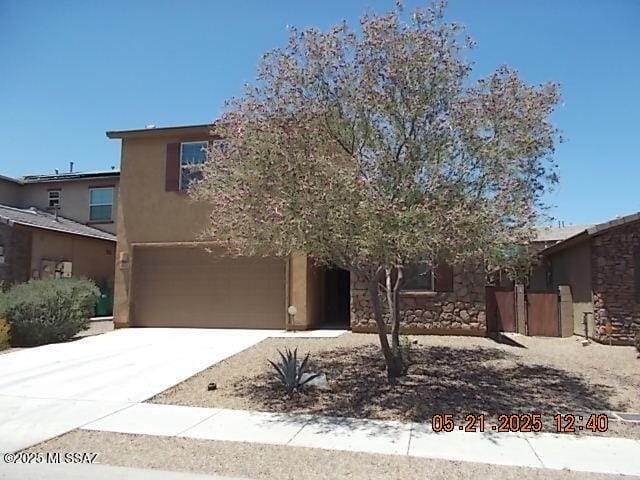 902 W Calle Tipoy, Sahuarita, AZ 85629 - view of front of property with stucco siding, a garage, concrete driveway, and stone siding