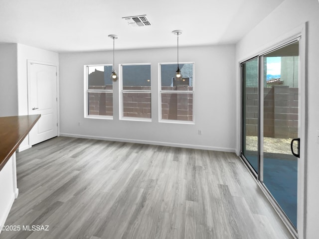 7637 E Cholla Overlook Dr, Tucson, AZ 85710 - unfurnished dining area with wood finished floors and baseboards