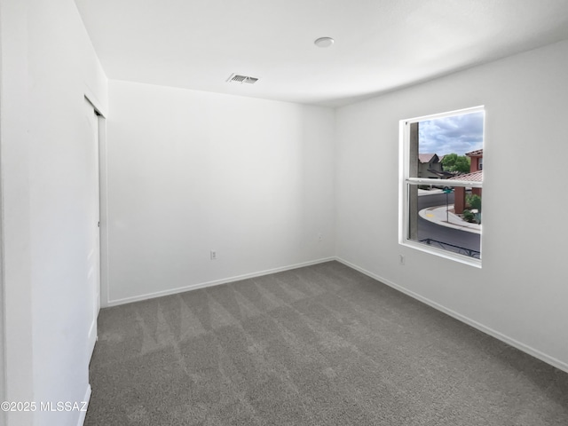 7637 E Cholla Overlook Dr, Tucson, AZ 85710 - carpeted spare room featuring baseboards