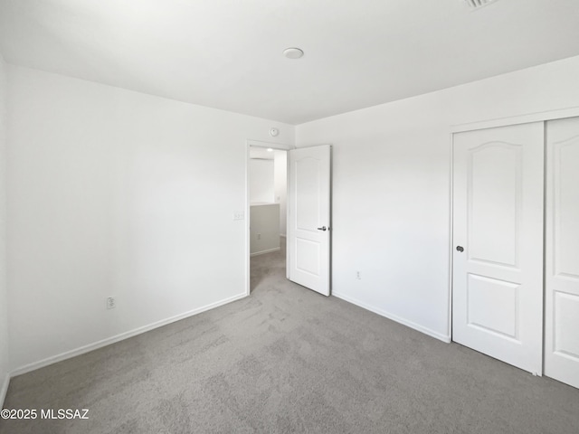 7637 E Cholla Overlook Dr, Tucson, AZ 85710 - unfurnished bedroom with carpet flooring, a closet, and baseboards