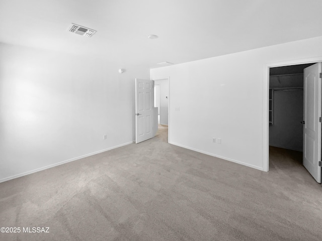 7637 E Cholla Overlook Dr, Tucson, AZ 85710 - unfurnished bedroom with carpet, a walk in closet, baseboards, and a closet