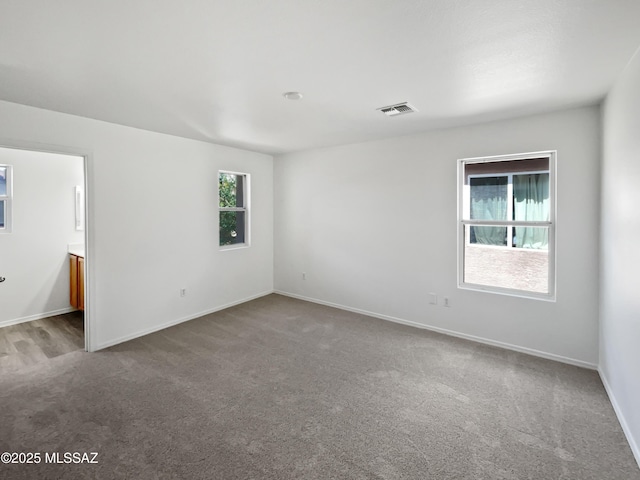 7637 E Cholla Overlook Dr, Tucson, AZ 85710 - carpeted spare room featuring baseboards