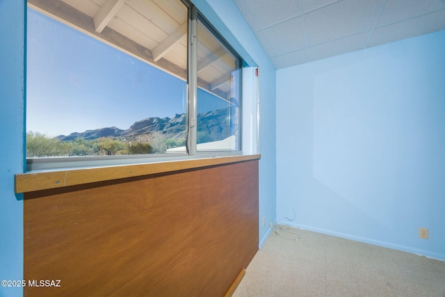 6532 N Cibola Ave, Tucson, AZ 85718 - empty room featuring a mountain view, carpet flooring, and baseboards
