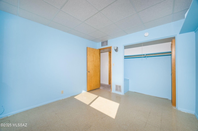 6532 N Cibola Ave, Tucson, AZ 85718 - unfurnished bedroom featuring a drop ceiling, a closet, and baseboards